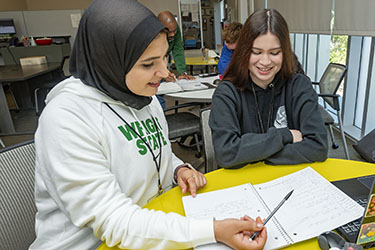 photo of two students working together at a table