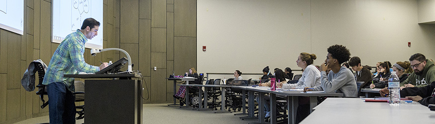 photo of an instructor and students in a lecture hall