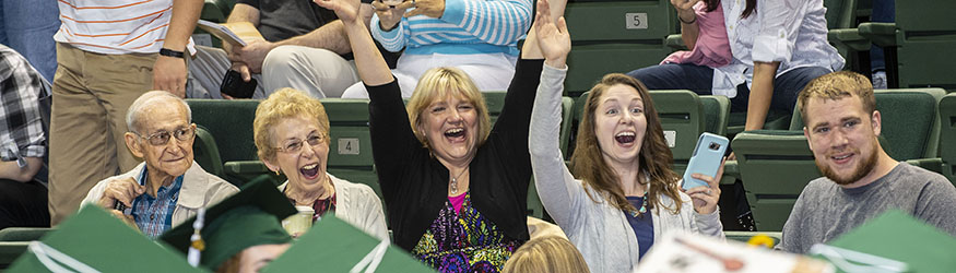 photo of family members cheering at commencement