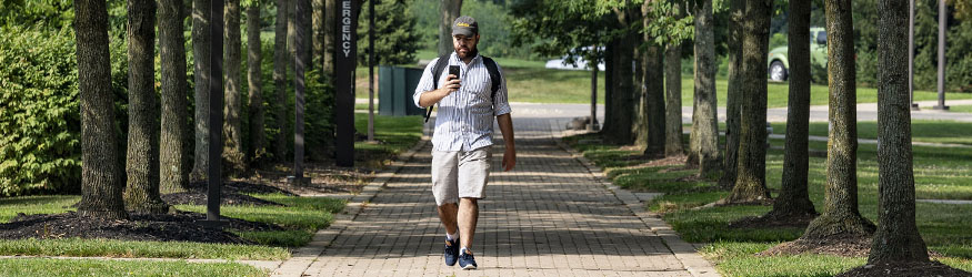 photo of a student walking outside on campus