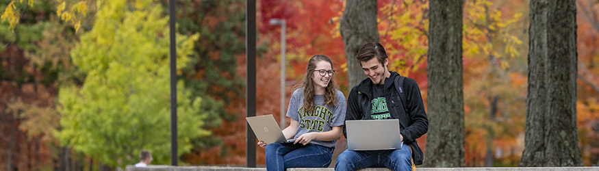 photo of students sitting outside on campus