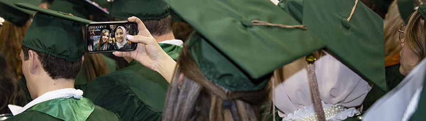 photo of graduates taking a photo at commencement