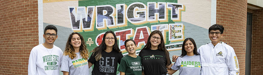 photo of a group of students standing in front of the welcome to wright state mural