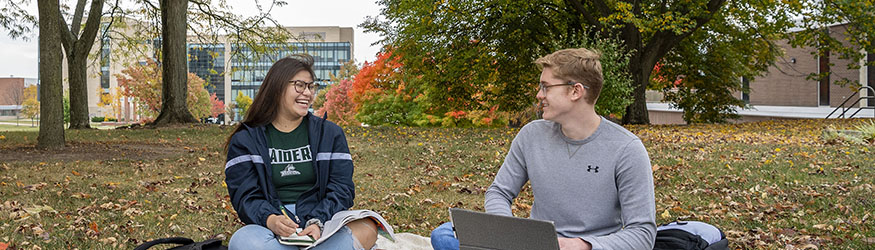 photo of students sitting outside on campus