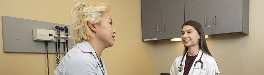 photo of a medical student and patient in an exam room