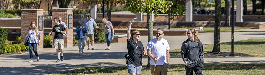 photo of students and family members walking outside on campus