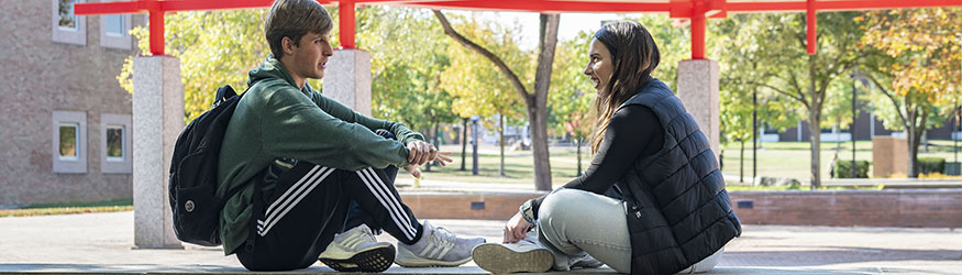 photo of students sitting outside on campus 