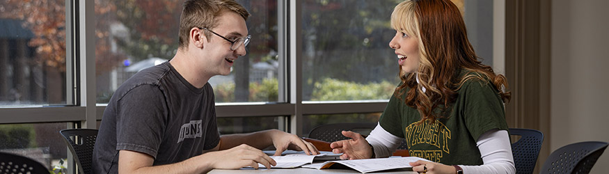 photo of two students sitting at a table in allyn hall