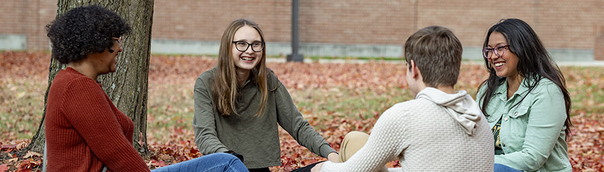 photo of students sitting outside on campus