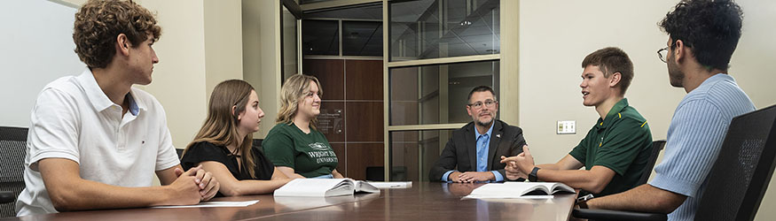 photo of students and a career advisor sitting at a table