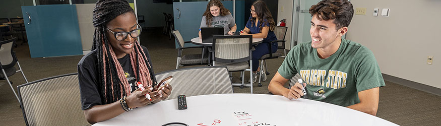 photo of students sitting at a table in the student success center