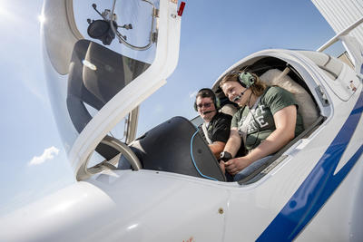 photo of a student and instructor in an airplane